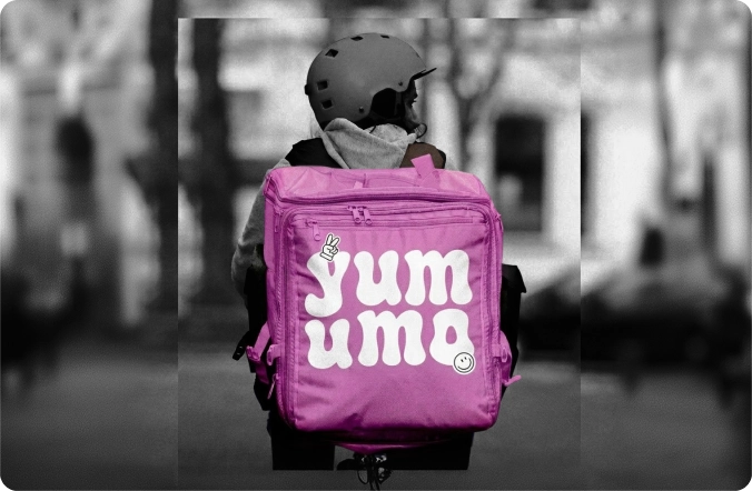Yummo branded backpack displayed in an urban setting